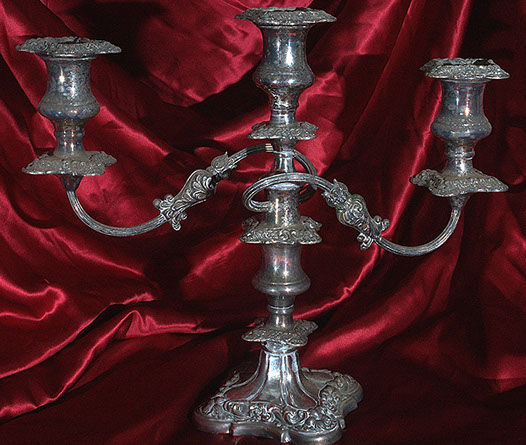 A tarnished silver candelabra before cleaning and polishing.